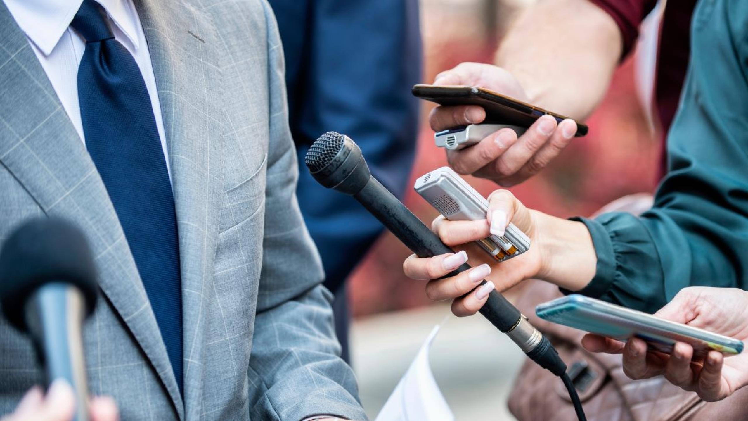 Journalisten met microfoons.